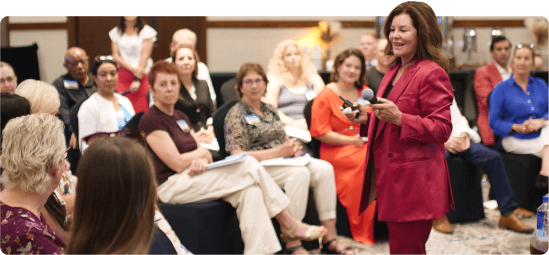 Sandy Gallagher standing and teaching an audience