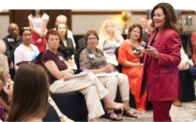 Sandy Gallagher speaking to a room of consultants at an event.