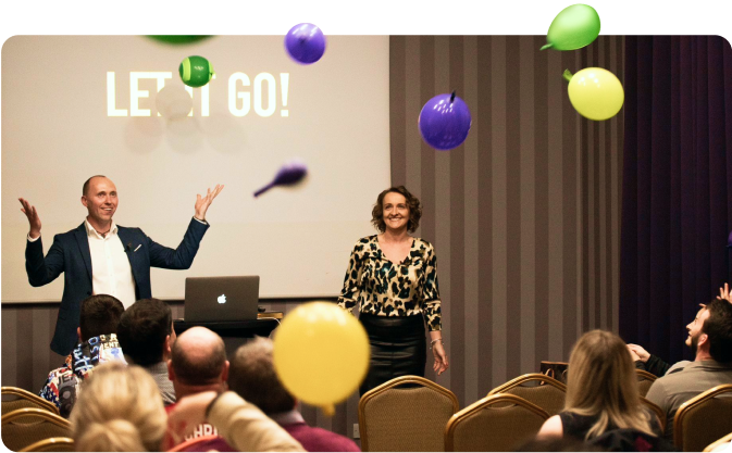 Sylvia and Tom Kornas presenting at an event.